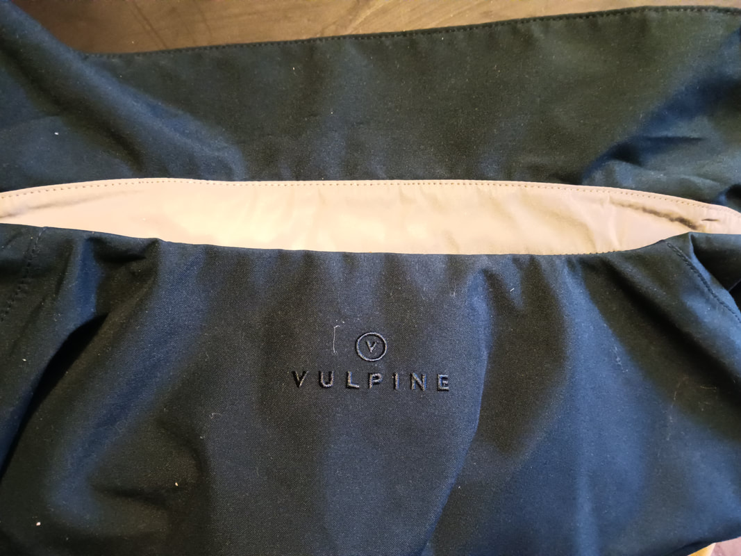 The reflective strip under the collar of Vulpine's Regents Mac