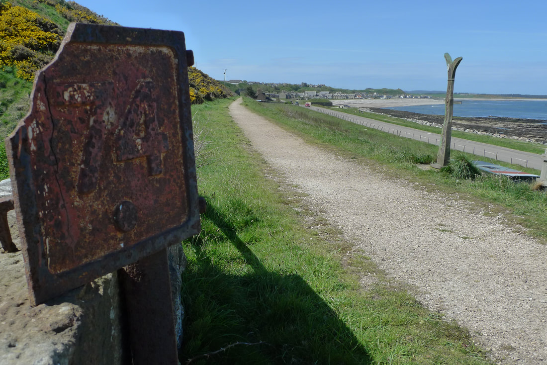 The approach to Portgordon with an old railway sign by the side of the cycle path