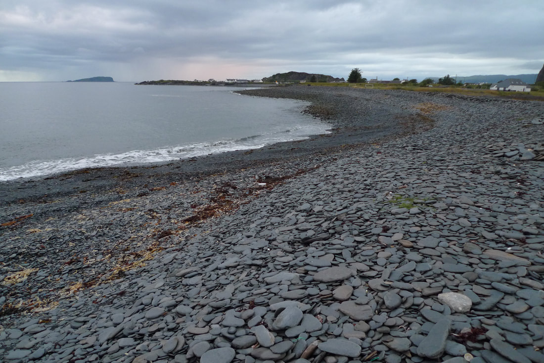 The beach at Ellenabeich is covered in shards of slate