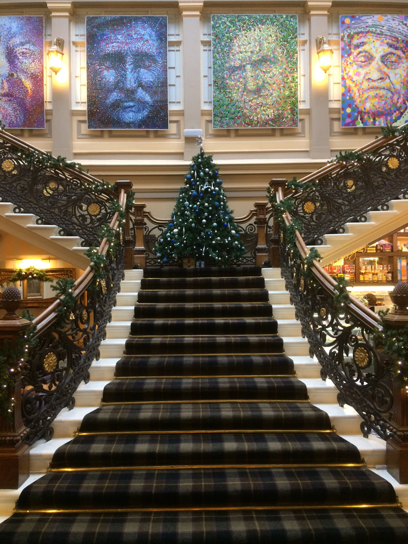 The staircase in The Royal Hotel at Christmas. There's a Christmas tree on the landing