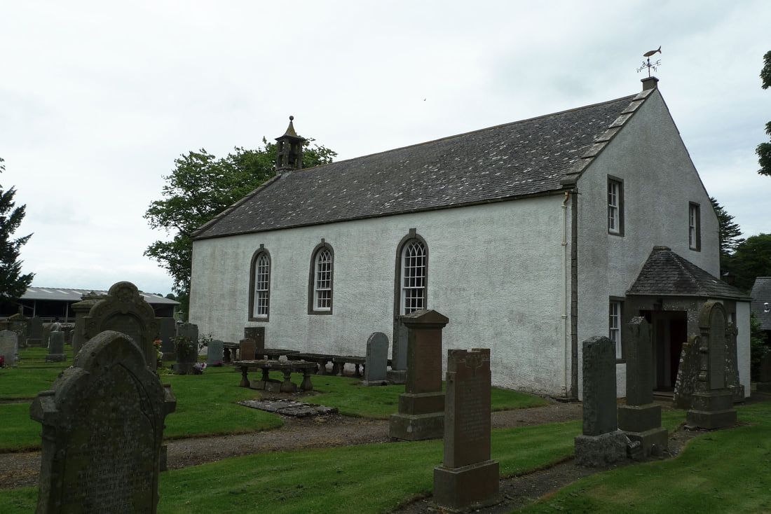 Inverarity Parish Church, painted white with gravestones around it