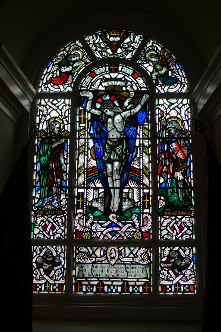 Stained glass in the chapel at Fort George. It has a bagpipe playing angel