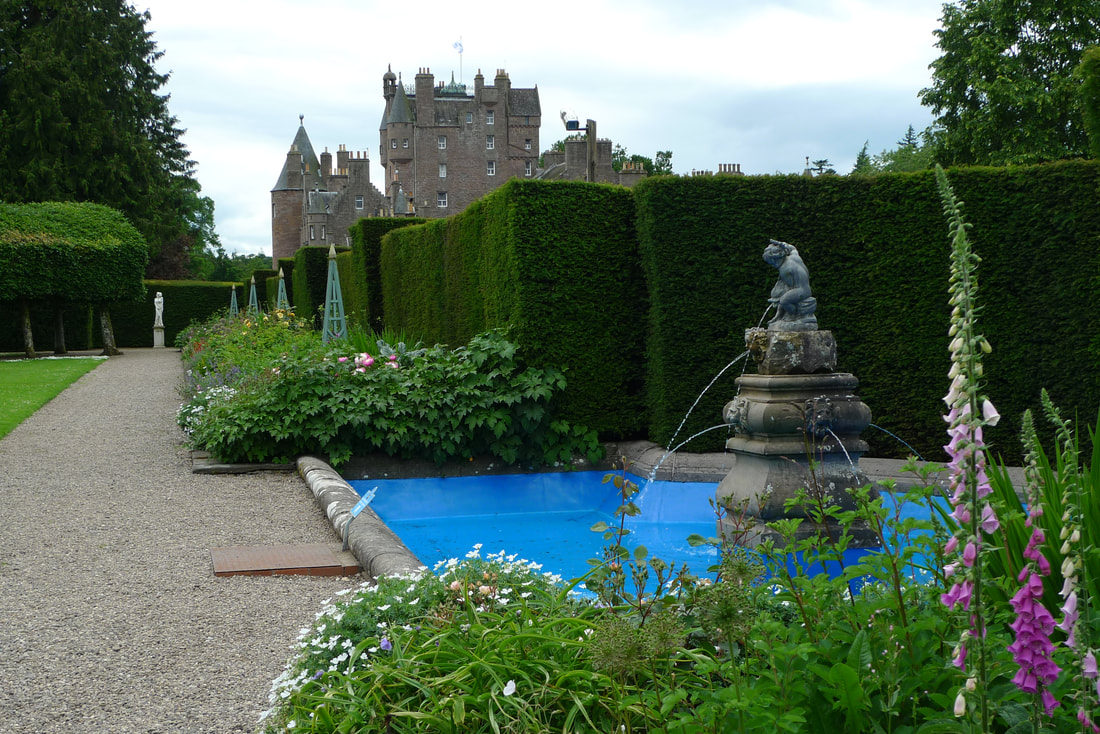 Italian Garden at Glamis Castle. There's a fountain and tall hedges.