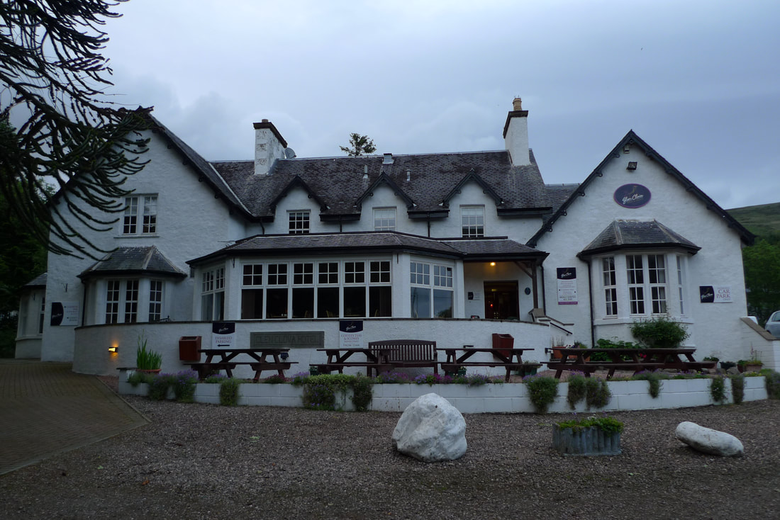 Glen Clova hotel, painted white with large windows on the ground floor