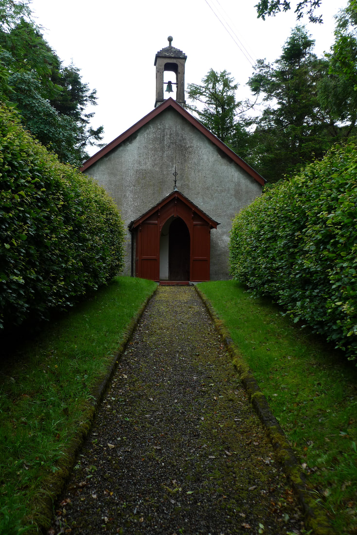 Kilninver Parish Church. A gravel path leads to the front door.