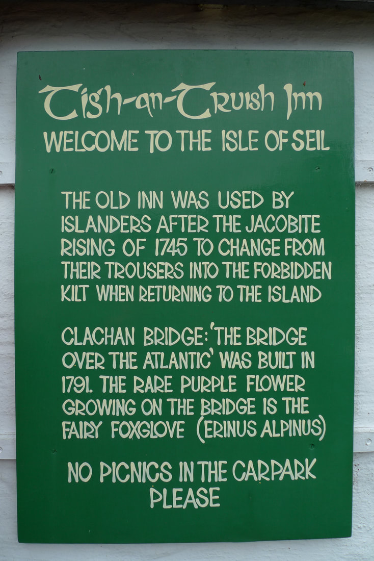 A sign that tells the history of the Clachan Bridge and the inn