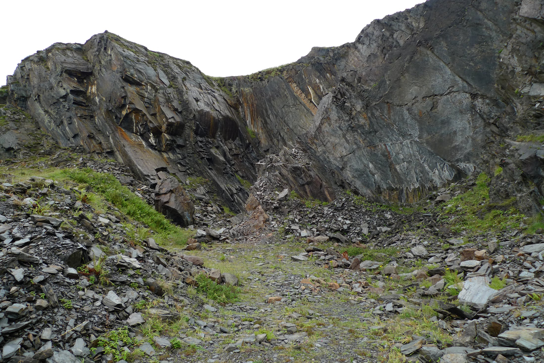 Remains of the slate quarry on Luing. Slate is littered all over the ground and there is a slate mountain that was blasted apart with explosives