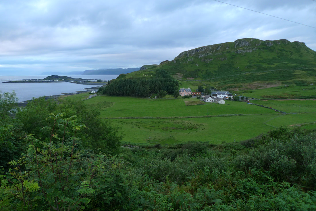 The view towards Ellenabeich. It's dominated by the craggy hill, Dun Mor, On the left of the picture is the island of Easdale