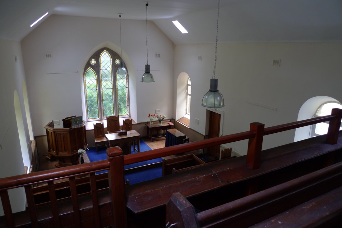 View from the upper gallery of Kilninver Parish Church. Looking down towards the pulpit and large arched window.