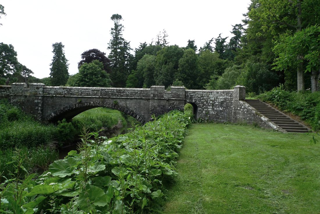 Jembatan Earl Michael di atas Air Dean di Kastil Glamis.  Jembatan batu dengan tangga menuju ke sana.
